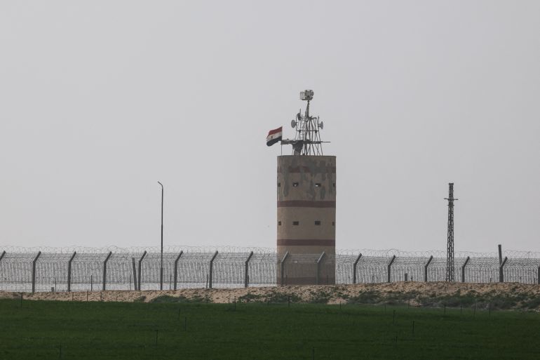 An Egyptian flag waving on a watch-tower by the Egypt side of the Israel Egypt border close to the southern part of the Gaza Strip, near Kerem Shalom crossing, February 2, 2026. REUTERS/Amir Cohen