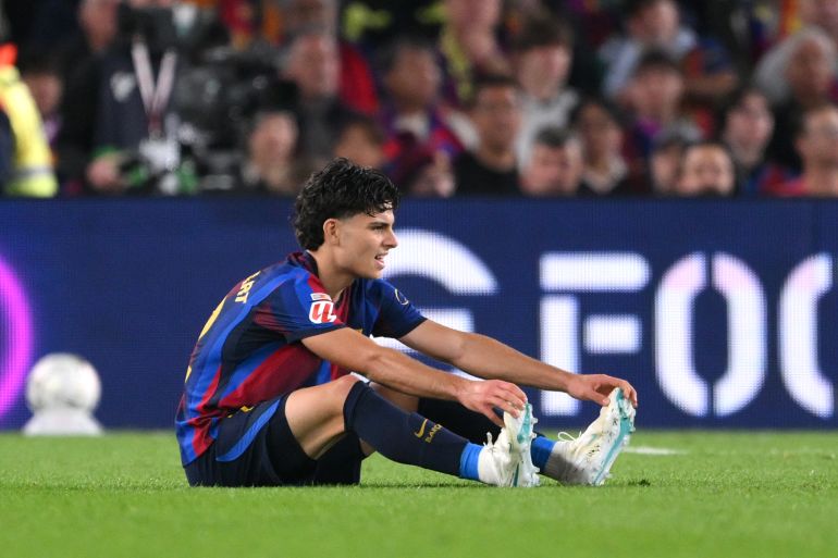 BARCELONA, SPAIN - OCTOBER 25: Xavi Espart of FC Barcelona sits on the pitch after sustaining an injury during the LaLiga EA Sports 2026/27 match between FC Barcelona and Real Madrid at Spotify Camp Nou on October 25, 2026 in Barcelona, Spain. (Photo by David Ramos/Getty Images)