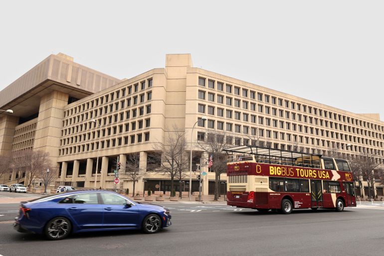 FILE PHOTO: A tour bus drives past the FBI headquarters, days after the Trump administration launched a sweeping round of cuts at the Justice Department, in Washington, U.S., February 3, 2025. REUTERS/Kevin Lamarque/File Photo