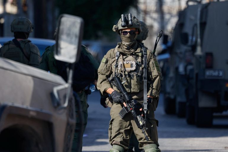 An Israeli soldier stands guard during a raid in Nablus, in the Israeli-occupied West Bank, October 7, 2026. REUTERS/Mohamad Torokman